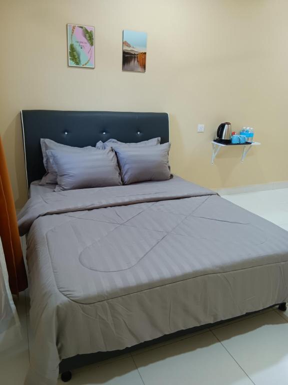 Postel nebo postele na pokoji v ubytování NURUL ROOMSTAY LANGKAWI
