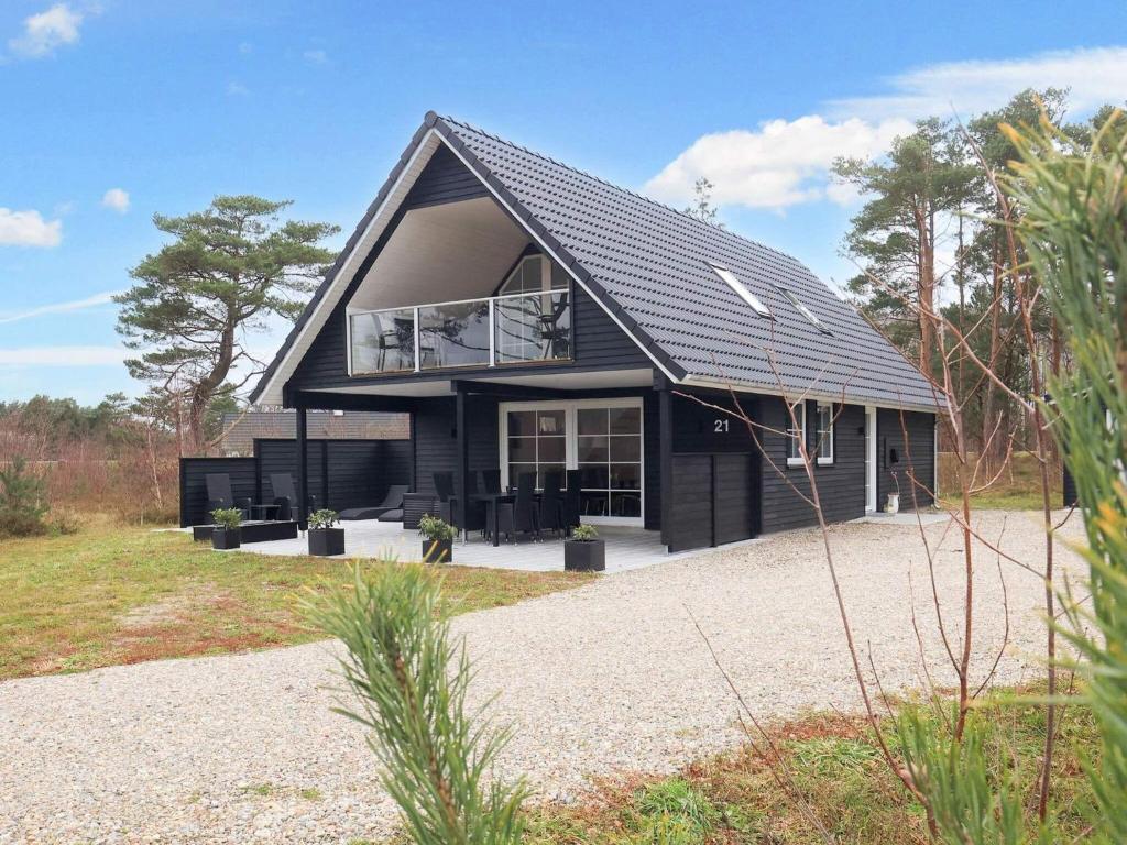 a black house with a black roof at Holiday home Læsø II in Læsø