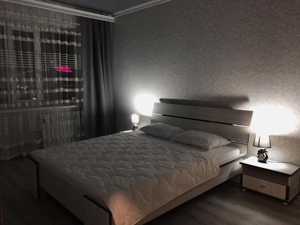 Katil atau katil-katil dalam bilik di Квартира в центре города , ЖК Наследие