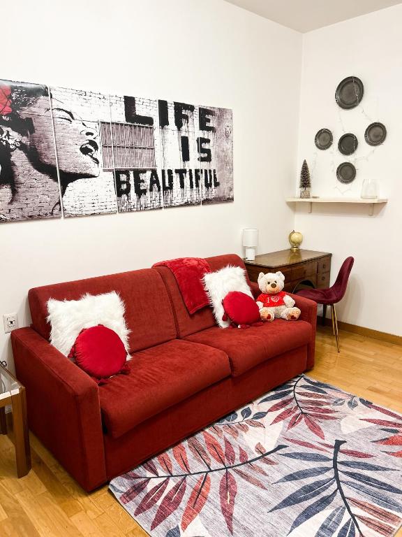 ein rotes Sofa mit roten Kissen im Wohnzimmer in der Unterkunft Como view apartment in Como