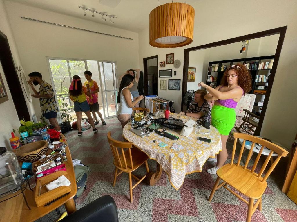 a woman is standing in a living room at Sobrado Fundição in Recife