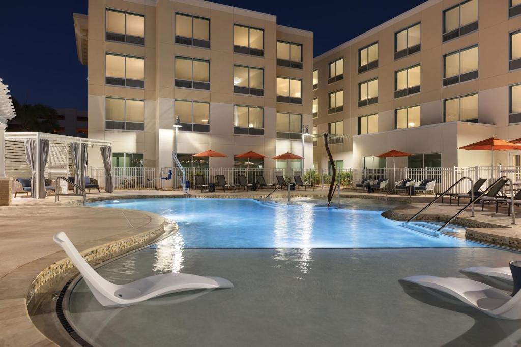 a swimming pool in front of a building at Holiday Inn Express Cape Canaveral by IHG in Cape Canaveral