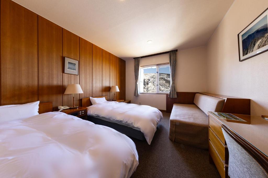 Postel nebo postele na pokoji v ubytování Hotel Tateyama