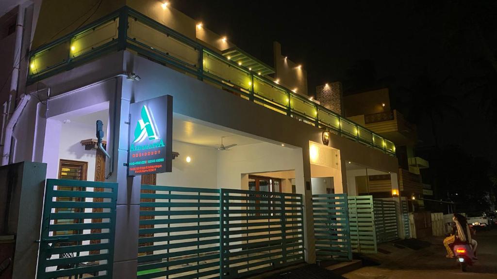 a building with a sign in front of it at night at Azhagappa Residency in Puducherry