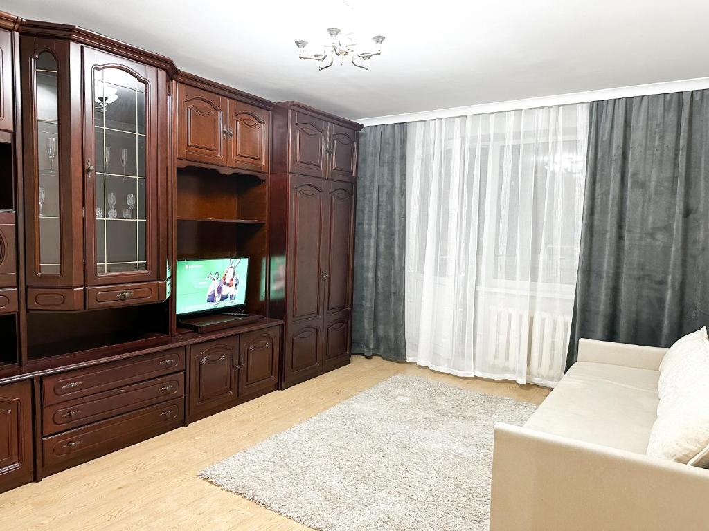a living room with a entertainment center and a tv at Central Apartment Pietonala in Chişinău