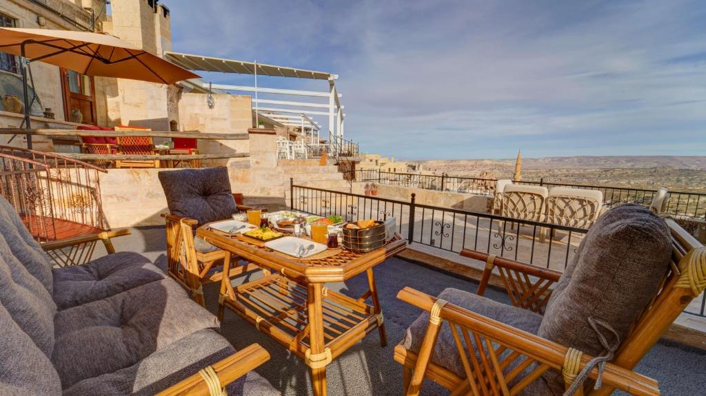 a patio with chairs and a table on a balcony at La Vie Cappadocia Suites in Nevşehir