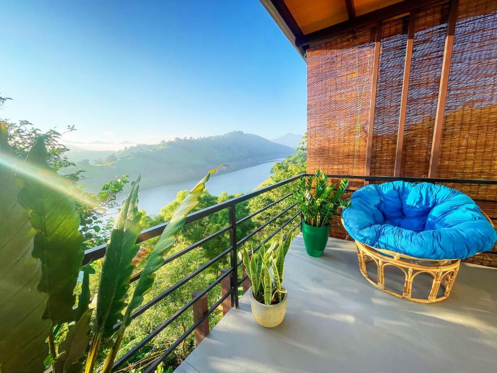 a balcony of a house with a view of a river at Che Resort in Digana
