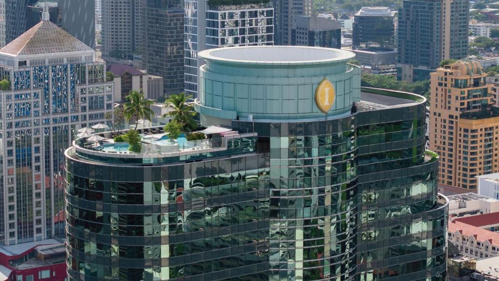 an aerial view of a tall building with palm trees on top at InterContinental Bangkok by IHG in Bangkok