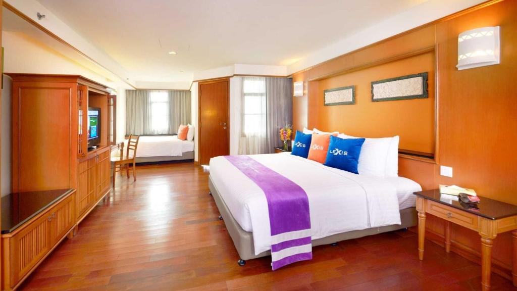 a hotel room with a large bed and a television at Le Seaview PortDickson in Port Dickson