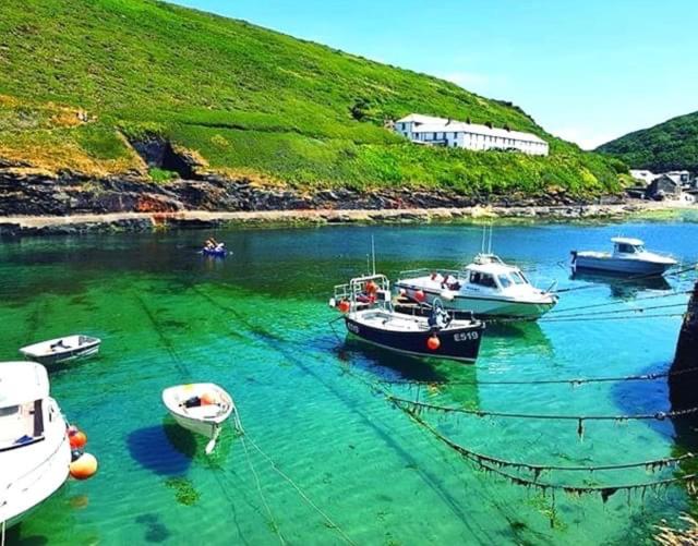 a group of boats in a body of water at Bantry Cottage at Crackington Haven, near Bude and Boscastle, Cornwall in Bude