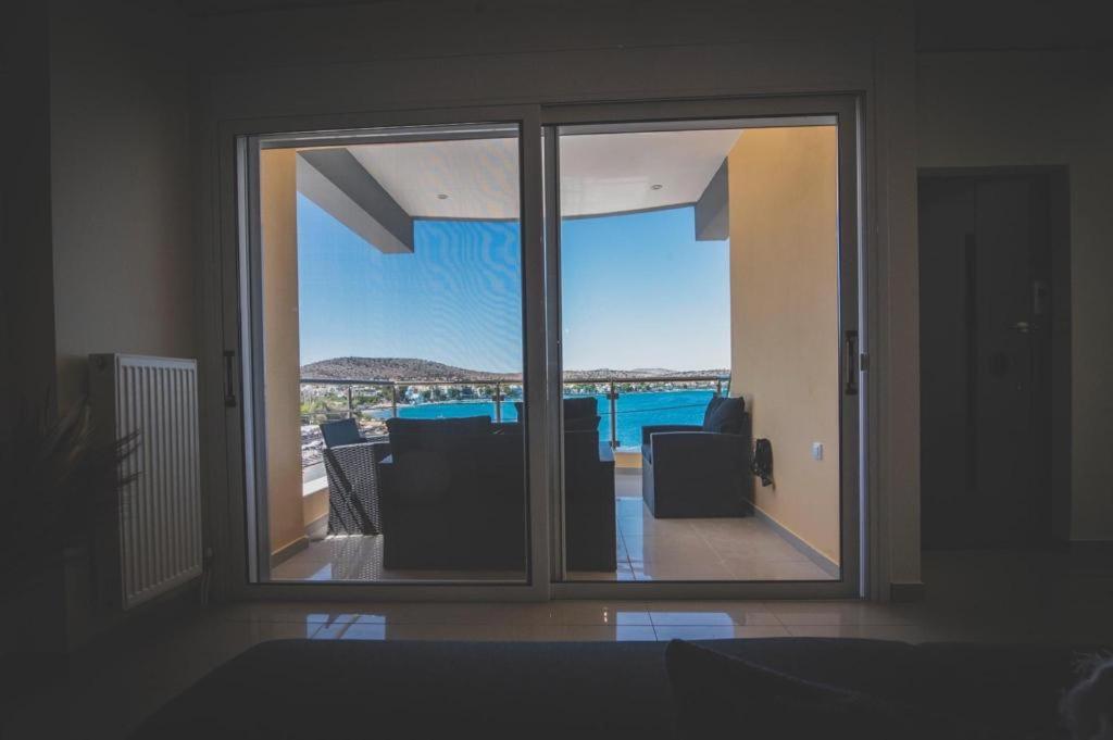 a view of a living room with a sliding glass door at Mardel_seaside_selinia in Salamina