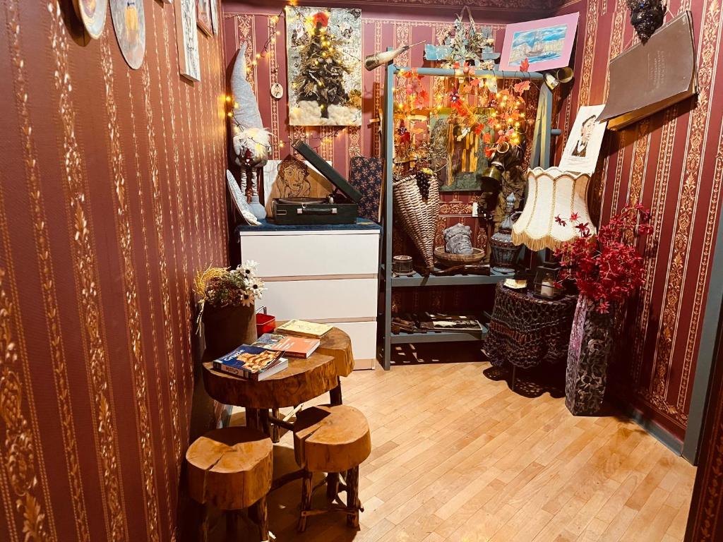 a shop with a table and stools in a room at Lets Go House in Tbilisi City