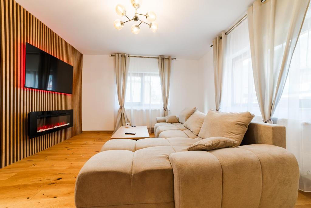 a living room with a couch and a fireplace at Carpe Diem in Bran