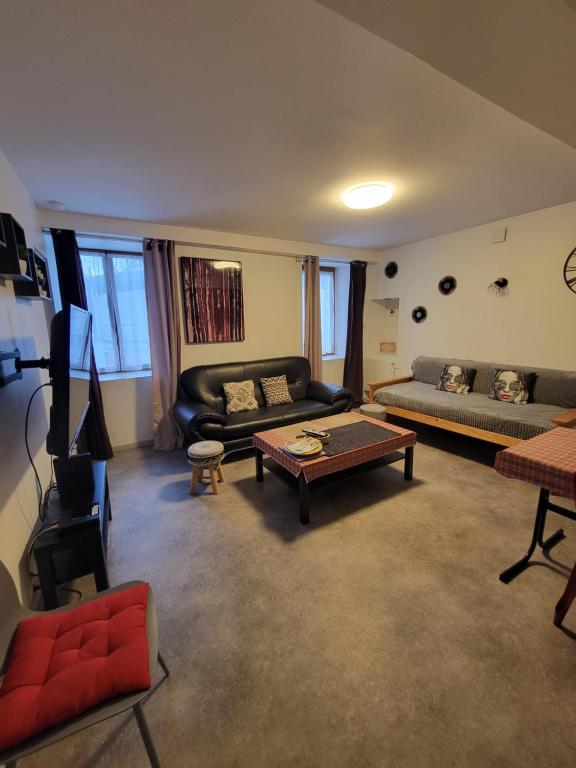 a living room with a couch and a table at sassenage au pied du Vercor 1 appartement in Sassenage