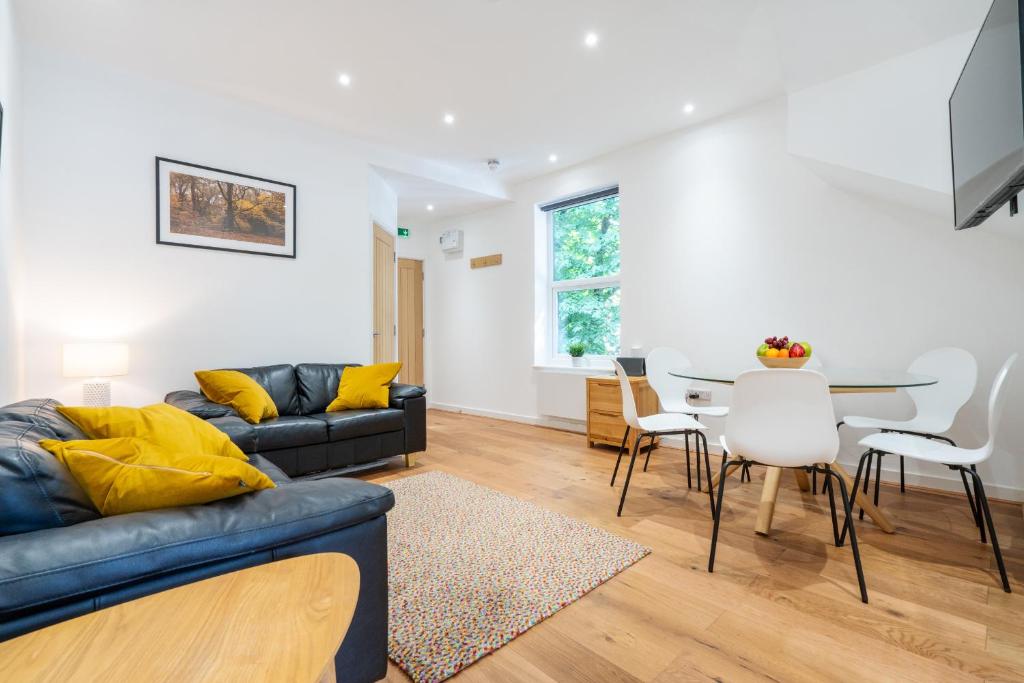 a living room with a couch and a table at The Botanical Flat 1 in Sheffield