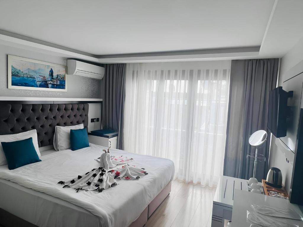 a bedroom with a large bed and a window at Maritime Hotel Istanbul in Istanbul