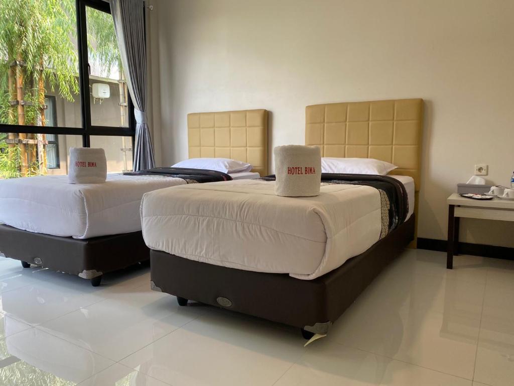 Postel nebo postele na pokoji v ubytování Hotel Bima Majalengka