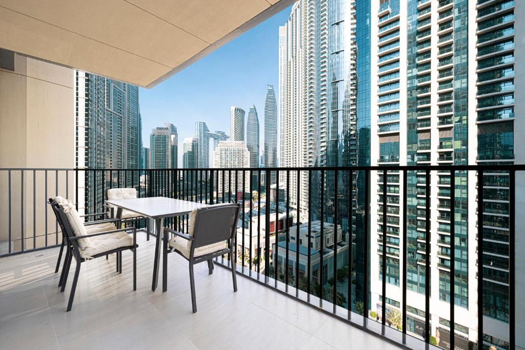 a balcony with a table and chairs and a view of the city at Magnificent Cozy 2BR in Downtown Dubai in Dubai