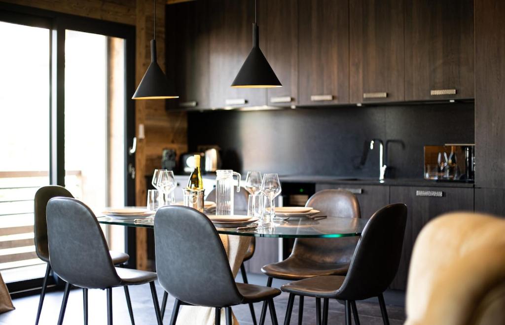 a dining table and chairs in a kitchen at A brand new apartment in a calm environment in Praz-sur-Arly