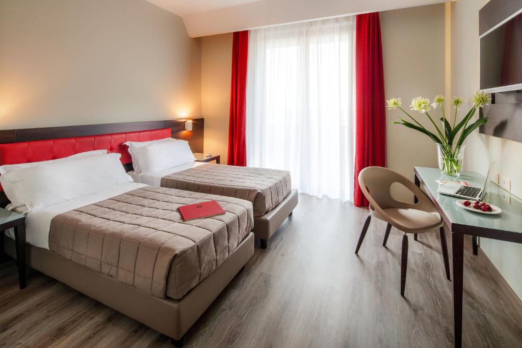 Postel nebo postele na pokoji v ubytování Hotel Da Vinci