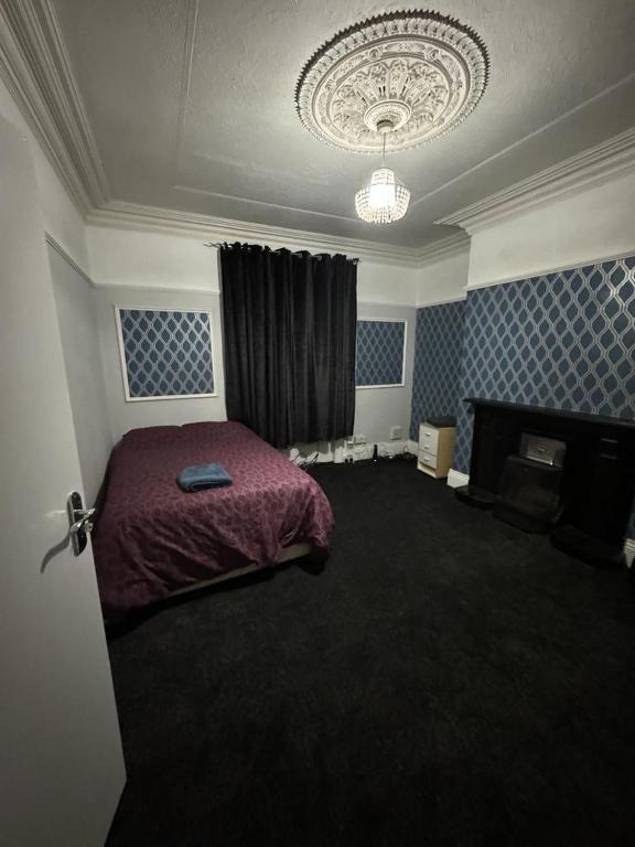 a bedroom with a bed and a fireplace in it at Victor's House in Huddersfield