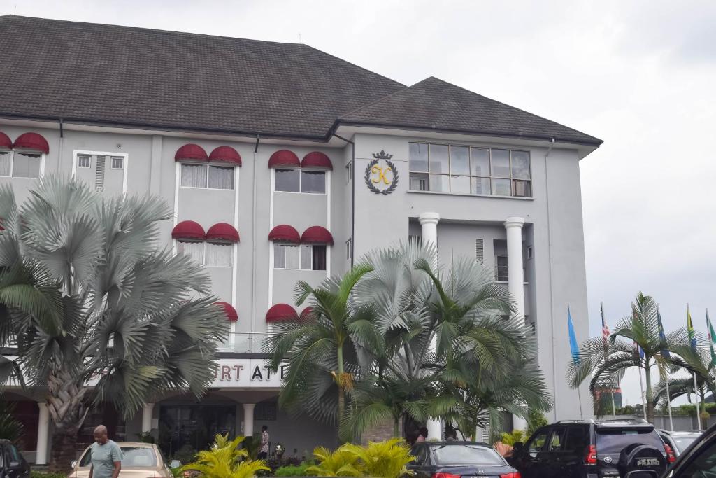 a large white building with a clock on it at Golden Tulip Hotel -GT31 Stadium Road in Port Harcourt