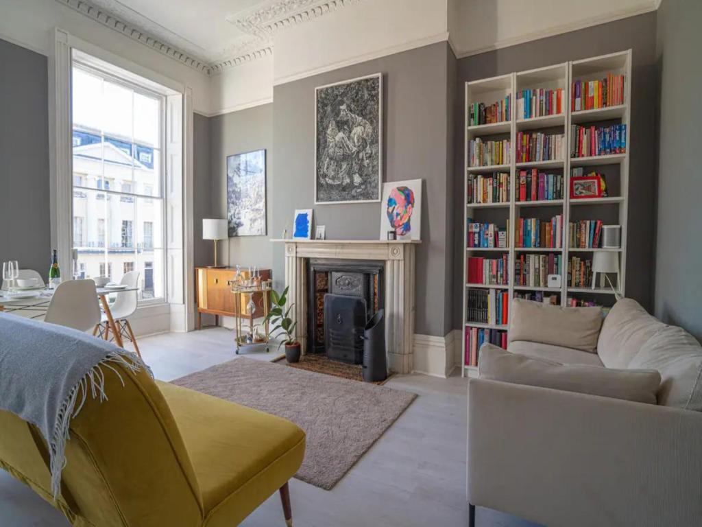 a living room with a couch and a fireplace at Pass the Keys Lovely bright and central apartment in Cheltenham in Cheltenham