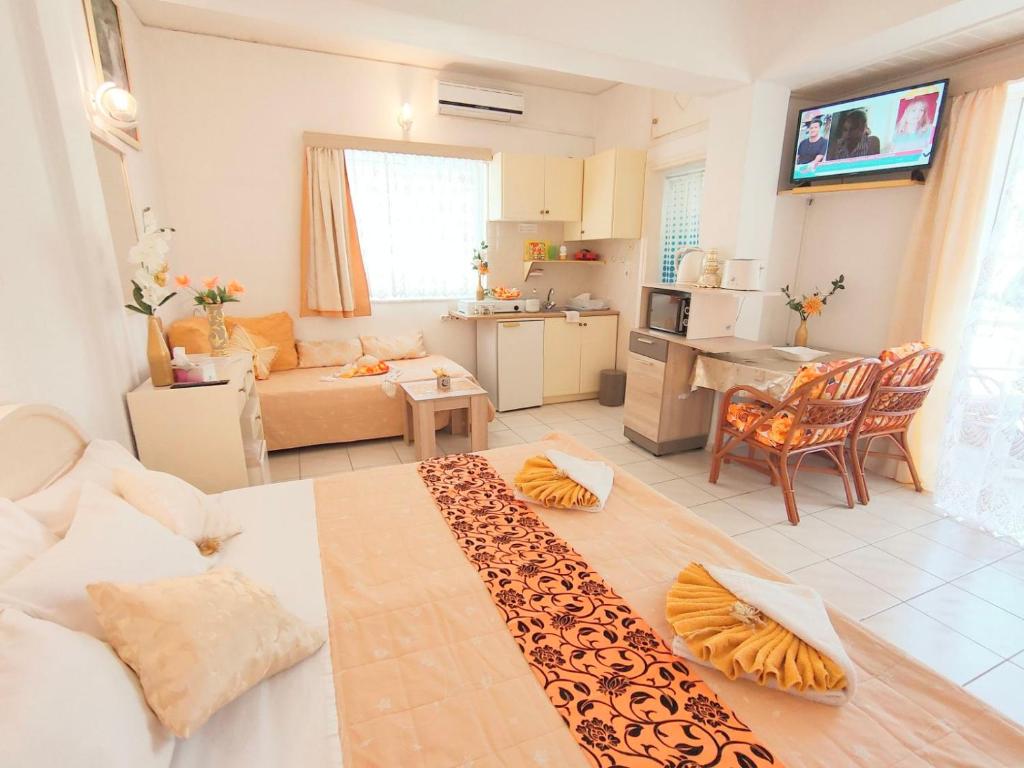 a living room with a couch and a kitchen and a living room at evli in Rethymno