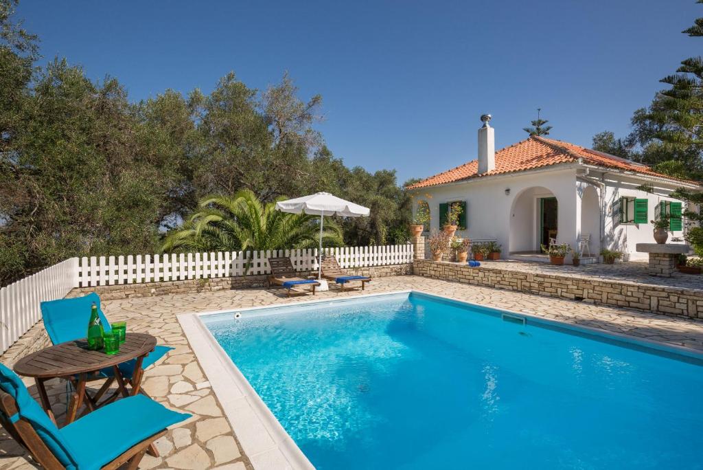 a villa with a swimming pool and a house at Villa Maria in Kagkátika