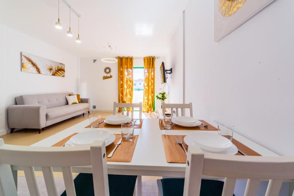 a dining room and living room with a table and chairs at Soleado en Alondras Park in Costa Del Silencio