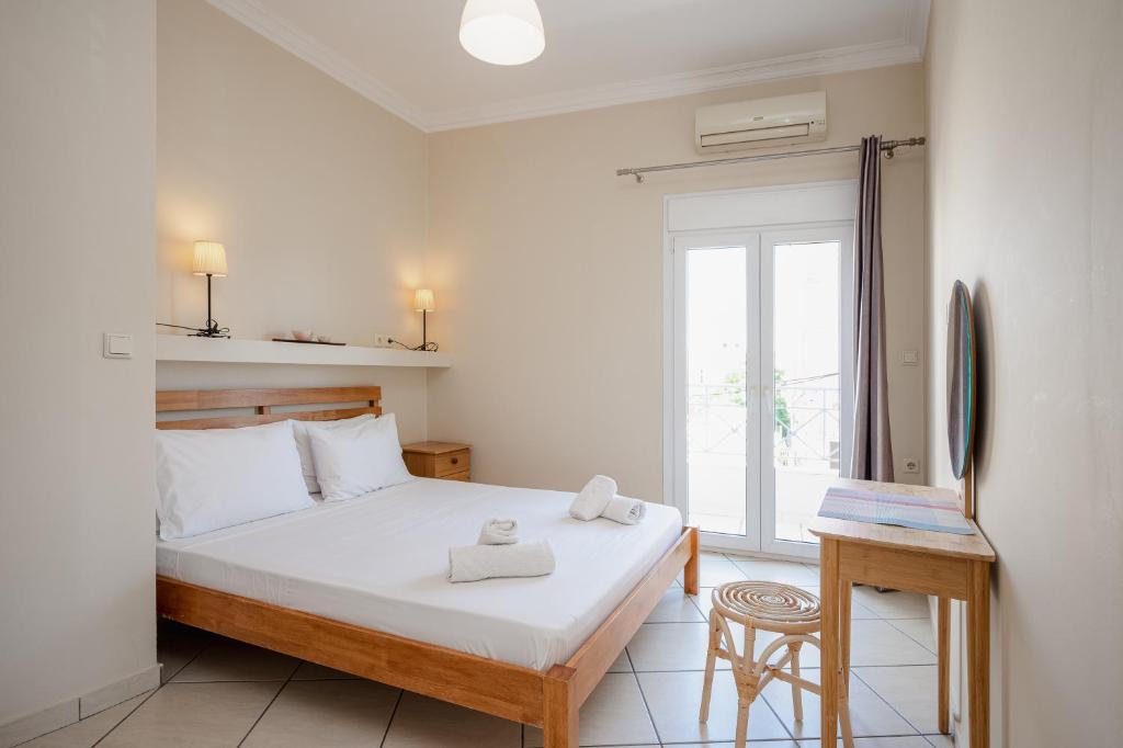 a bedroom with a bed with two towels on it at Jenny Apartments in Zakynthos Town