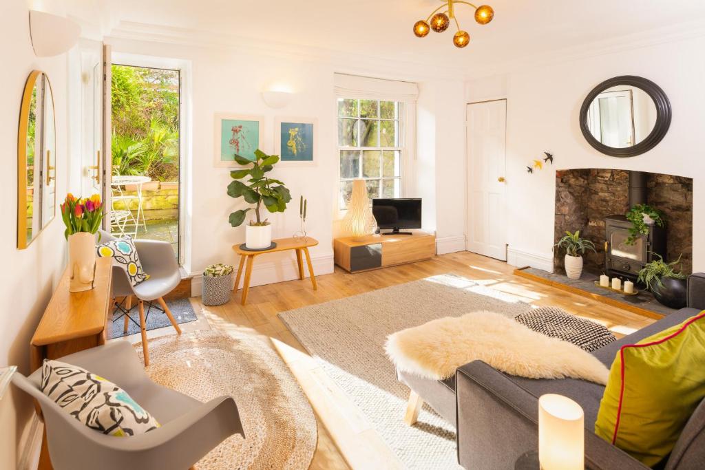 a living room with a couch and a fireplace at Idyllic Clifton Hideaway - Stunning Garden Flat in Bristol