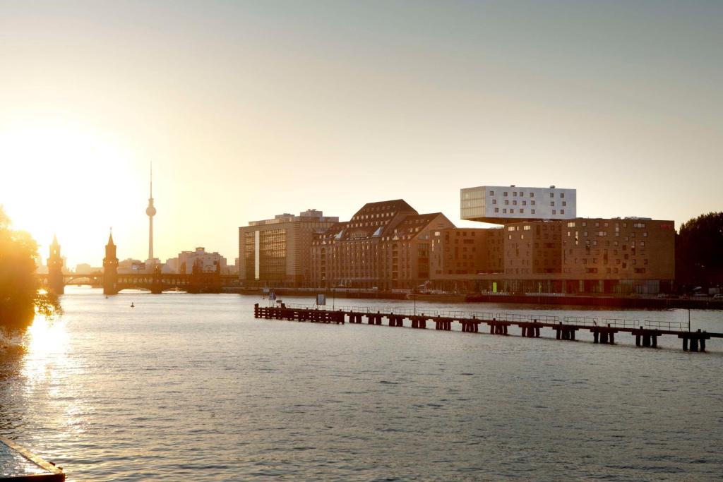 a river with a pier in the middle of a city at nhow Berlin in Berlin