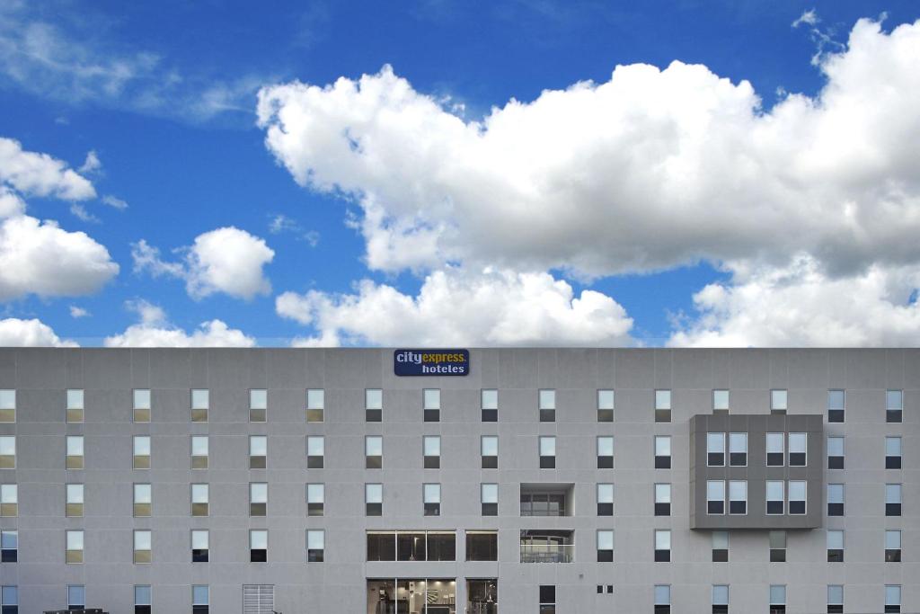 a building with a blue sign on top of it at City Express by Marriott Tlalnepantla in Mexico City