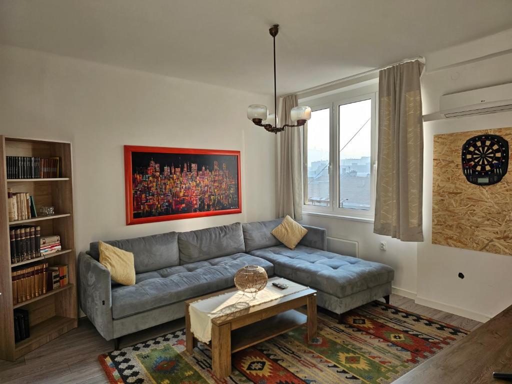 a living room with a couch and a table at Loga Apartment in Sarajevo