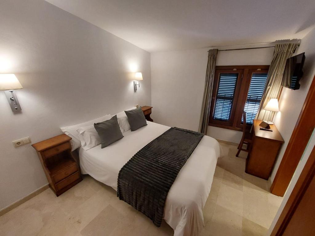 a bedroom with a bed with white sheets and pillows at My Rooms Manacor Centre by My Rooms Hotels in Manacor