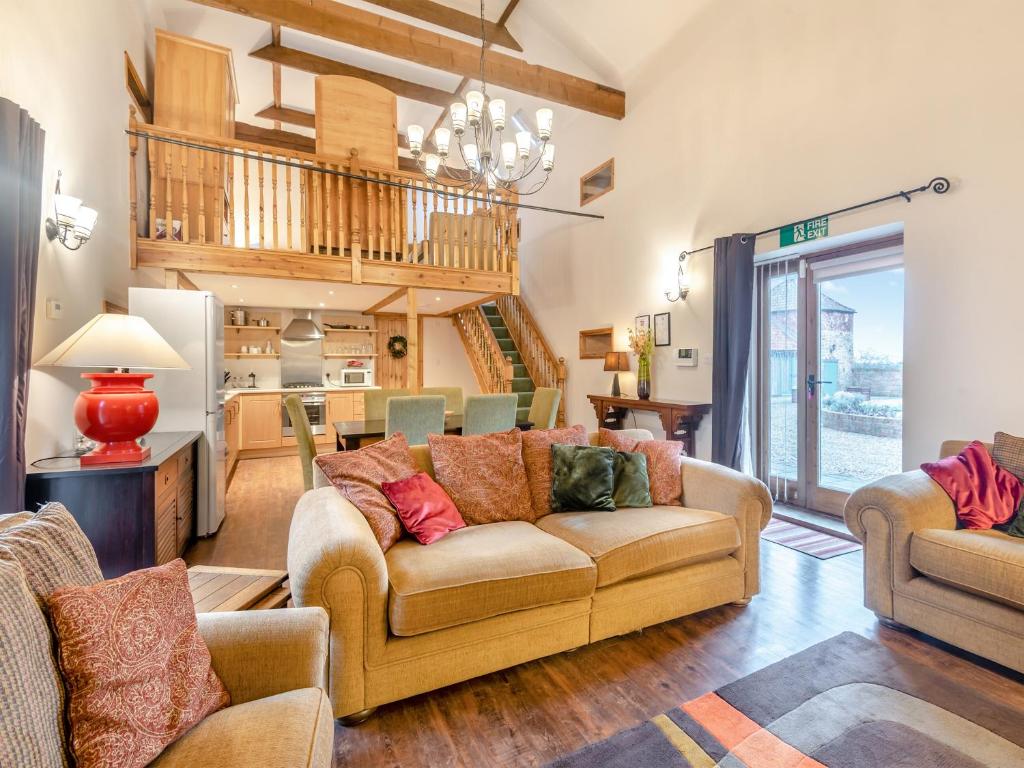 a living room with a couch and a kitchen at The Barn - Uk44514 in Tetney