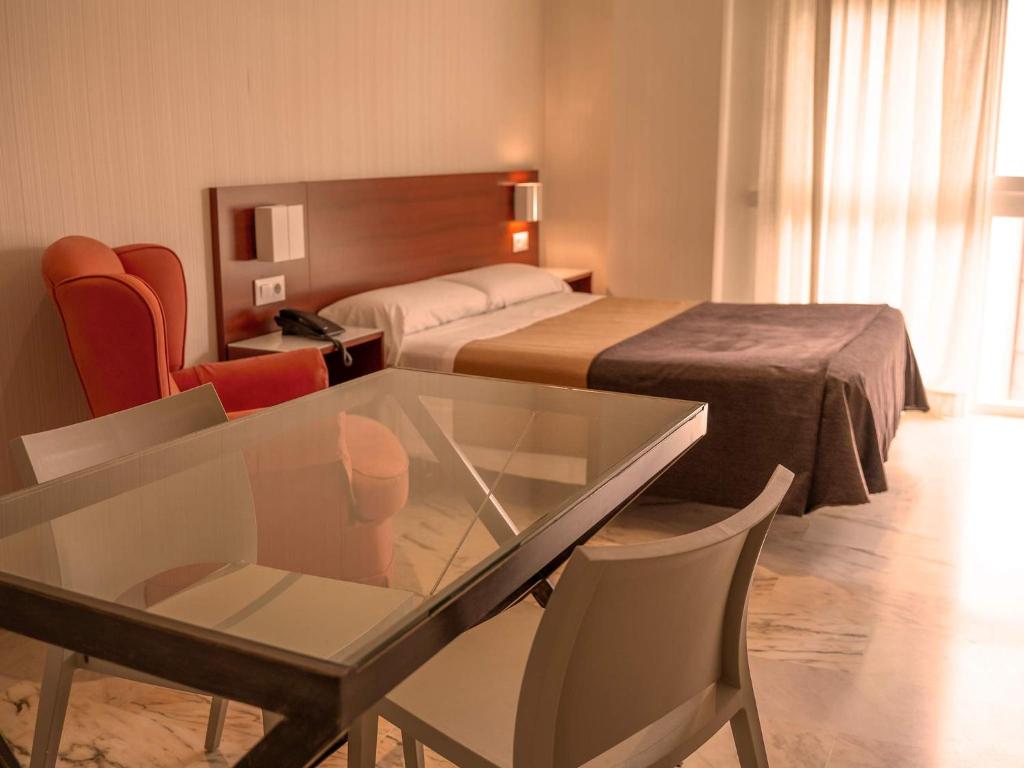 Posteľ alebo postele v izbe v ubytovaní Apartamentos Vértice Bib Rambla