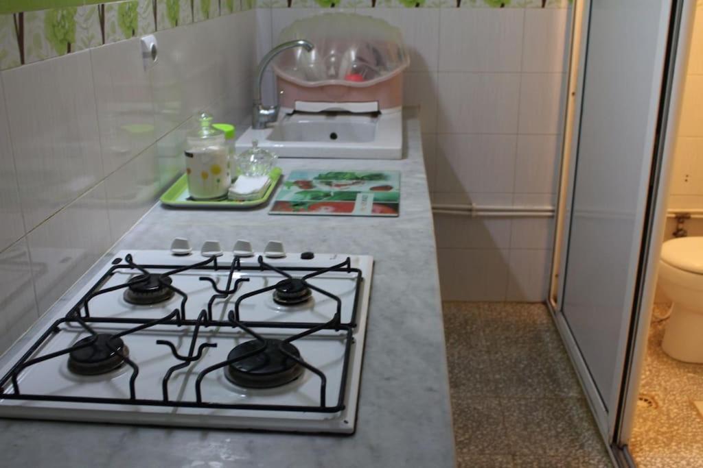 a kitchen counter with a stove and a sink at Niveau de Villa entre Béjaïa et Jijel (Ziama) in Jijel