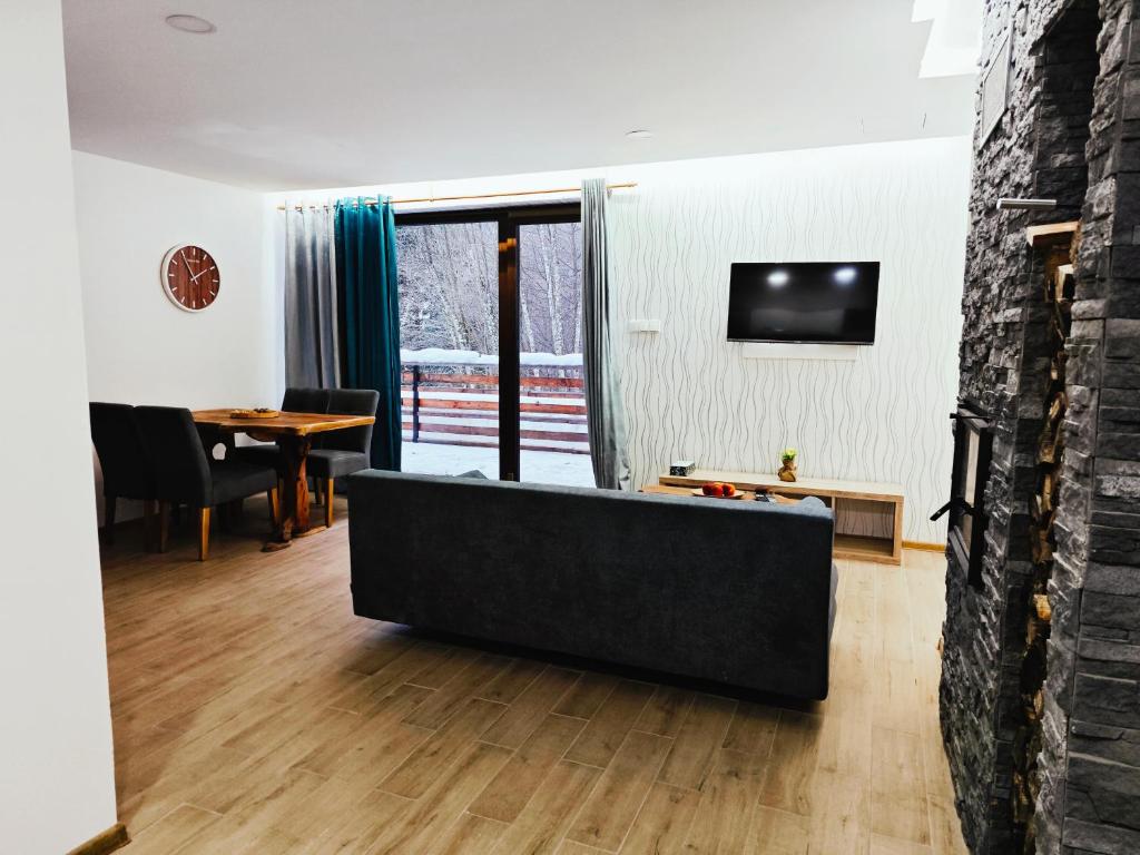 a living room with a couch and a table at Chalety Bystrá in Bystrá