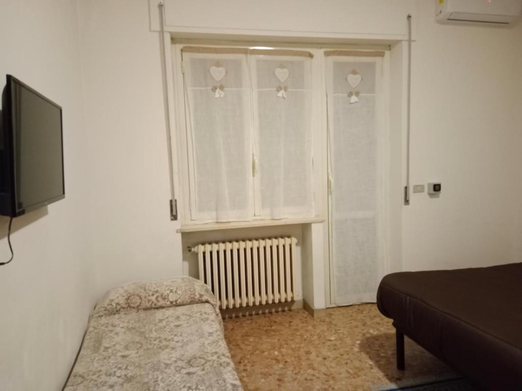 a room with a window and a couch and a television at Villa di Pietro in Pescara