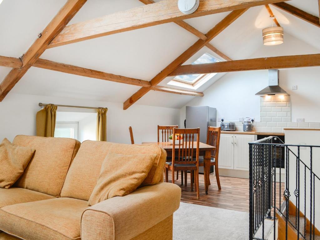 a living room with a couch and a table at Criffel Cottage in Ruthwell