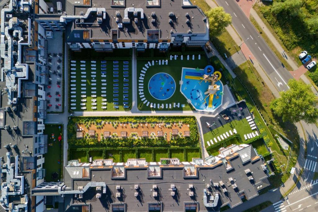 an aerial view of a building with a clock at Miedzyzdroje SEASIDE Apartments Bel Mare by Renters in Międzyzdroje