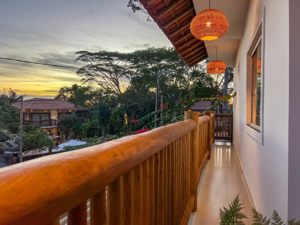 a balcony with a view of the sunset on a house at Residencial Villa I in Trancoso