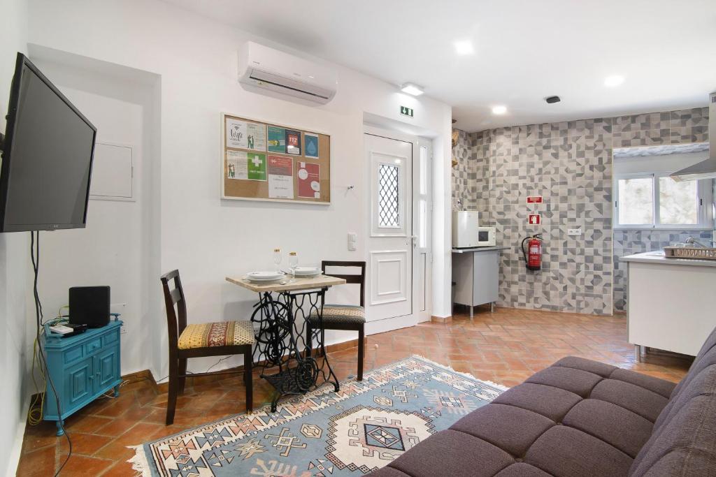 a living room with a couch and a table at Casa da Vila nº 6 in São Brás de Alportel