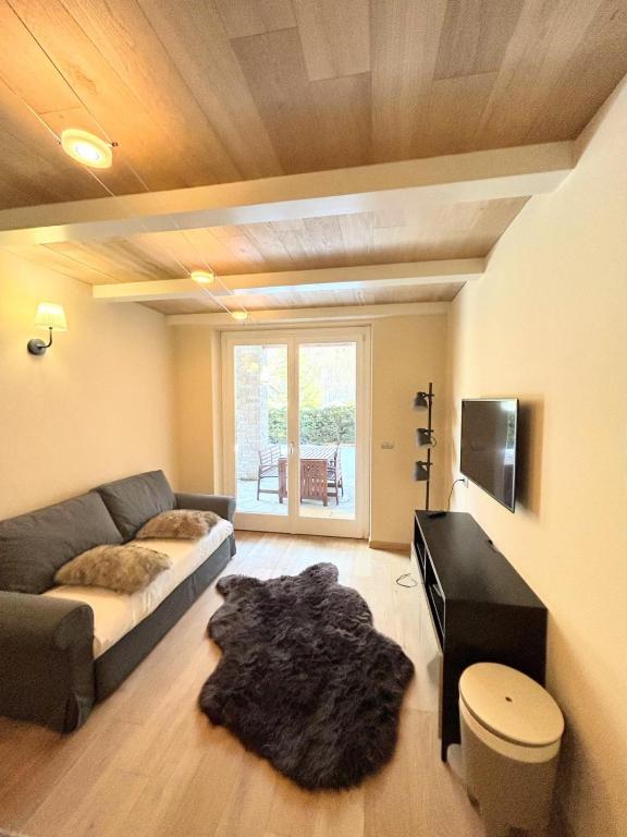a living room with a couch and a table at Le Petit Chalet Limone in Limone Piemonte