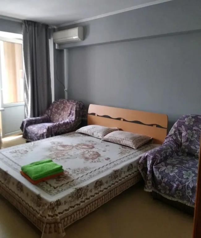 una camera con letto, divano e sedia di Однокомнатная квартира в центре города, Панфилова 80, Алматы a Almaty