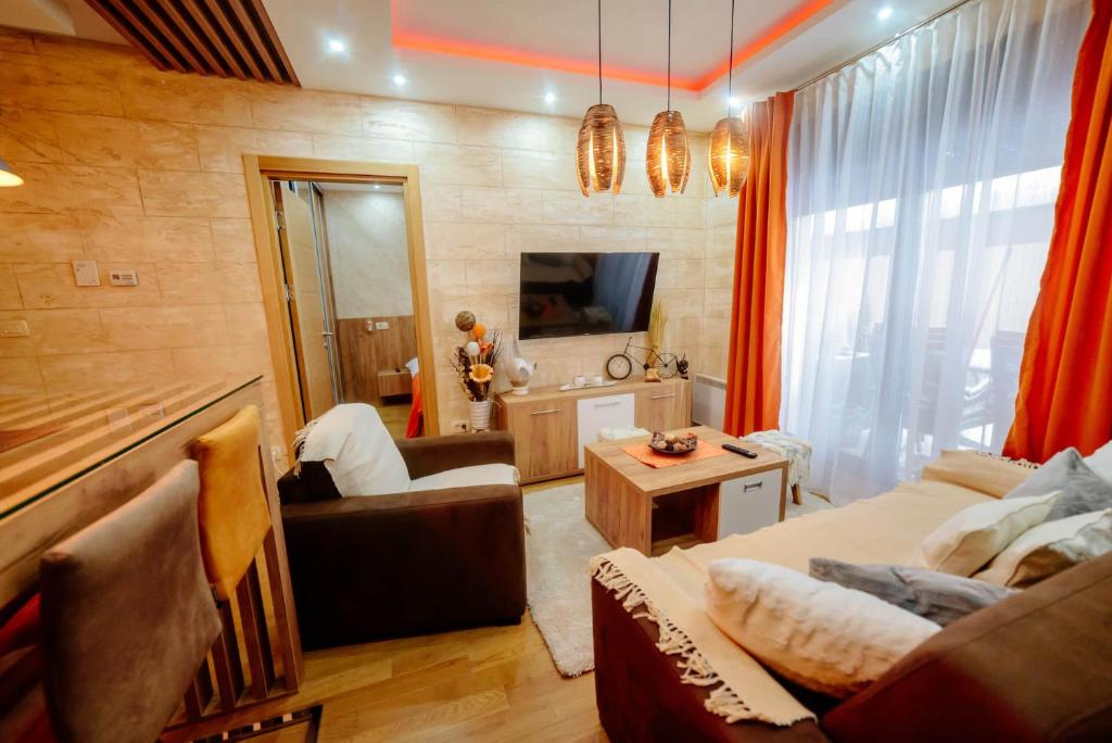 a living room with a couch and a table at Zlatibor Vila Peković Green S4 in Zlatibor