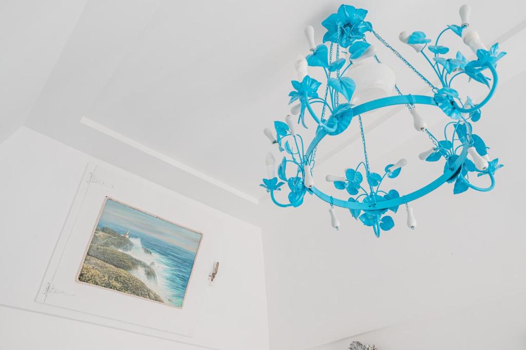 a blue chandelier with a picture of the ocean at La Bella Annacapri in Anacapri