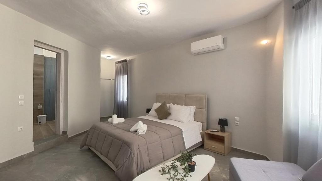 a bedroom with a bed and a living room at Sidus Condos in Veria